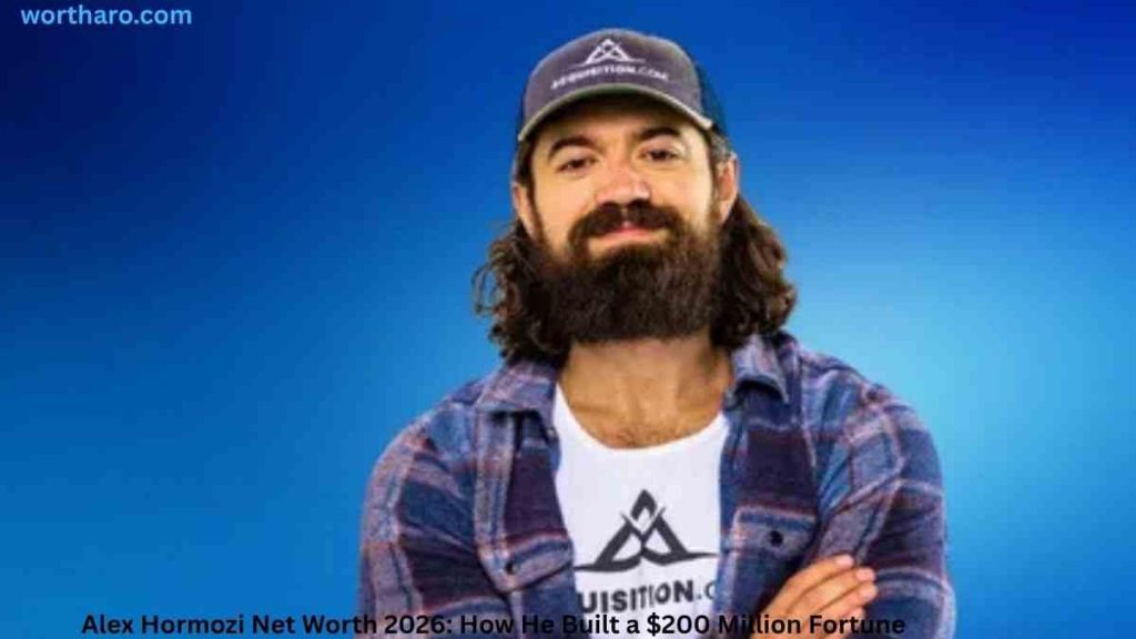 Alex Hormozi posing in a cap and plaid shirt | Alex Hormozi Net Worth