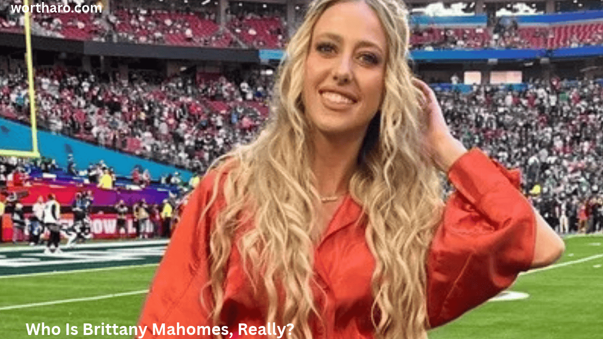 Brittany Mahomes Net Worth 2026 – Brittany Mahomes standing on a football field at a stadium.