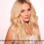 Megan Moroney Net Worth – Country music star Megan Moroney posing in a white outfit during a promotional photoshoot.