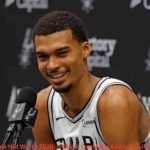 Victor Wembanyama Net Worth – smiling during a San Antonio Spurs press conference
