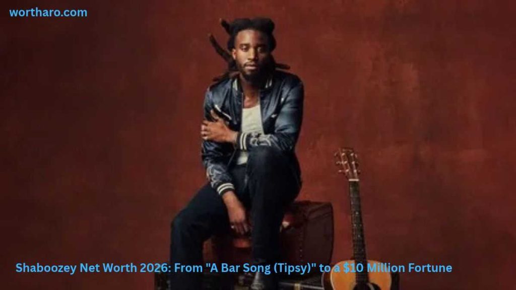 Shaboozey sitting with a guitar | Shaboozey Net Worth