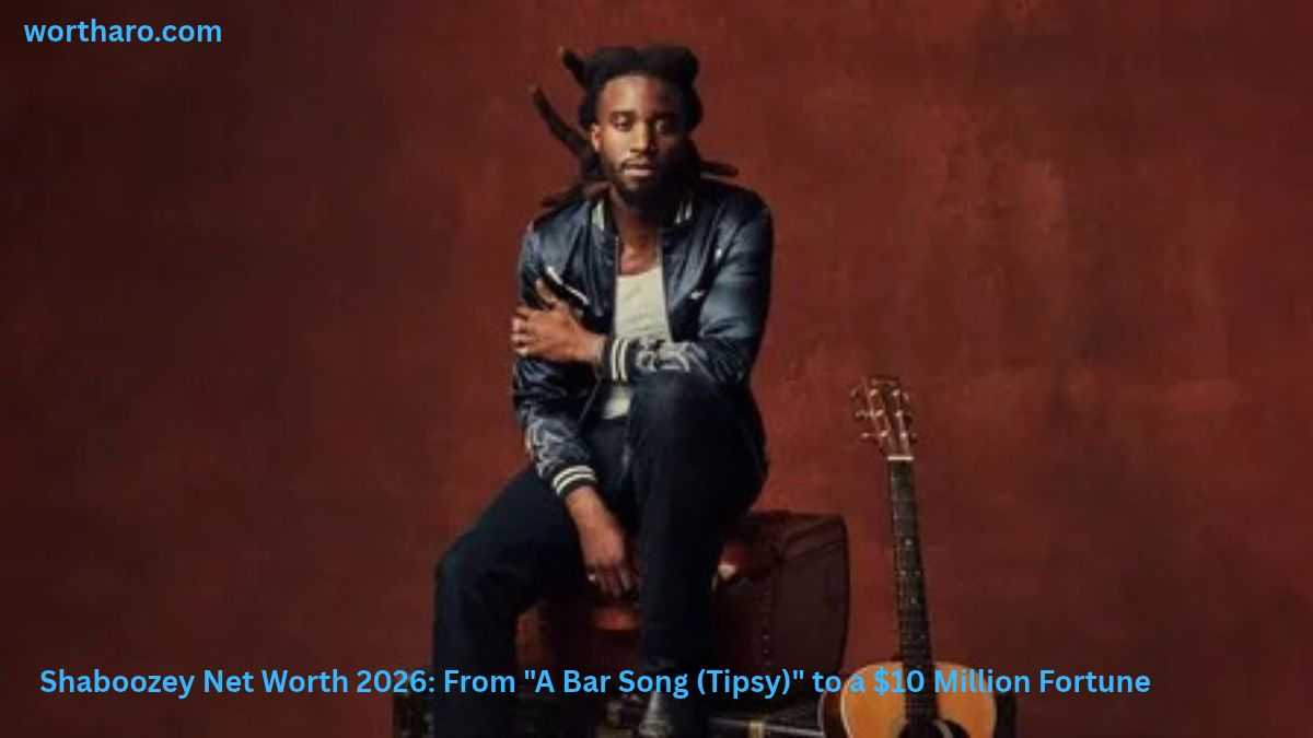 Shaboozey sitting with a guitar | Shaboozey Net Worth