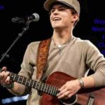 Waylon Wyatt performing on stage with a guitar and microphone while highlighting his country music career and Waylon Wyatt Net Worth